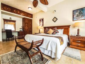a bedroom with a bed and a chair and a desk at La Buena Vibra Retreat and Spa Hotel Adults Only in Tepoztlán