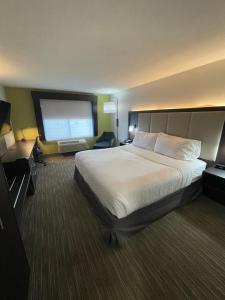 a hotel room with a bed and a flat screen tv at Holiday Inn Express Hotel & Suites Las Vegas by IHG in Las Vegas +71 photos