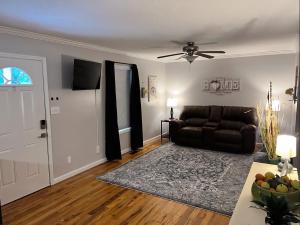 a living room with a couch and a ceiling fan at Kid-Friendly Townhouse Near Lake & Sports Complex in Guntersville