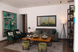 a living room with a couch and a table at Suites Casa 95 in Bogotá