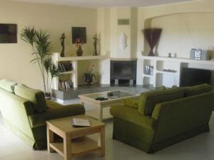 a living room with two couches and a table at Vila Nova- by Portugalferias in Carvoeiro