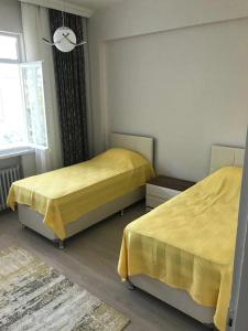 Postel nebo postele na pokoji v ubytování Hacısalihoğlu Apart