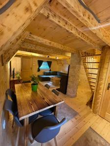 a dining room with a wooden table and chairs at Rajska suma in Žabljak +25 photos