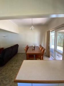 a living room with a dining room table and chairs at The Cottage in Mildura