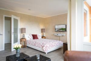 a bedroom with a bed and a tv on the wall at Apartment Plön Seeblick in Plön