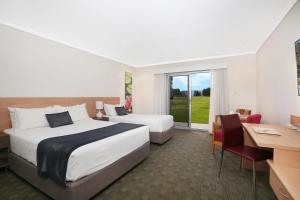 a hotel room with a bed and a desk at Springs Shoalhaven Nowra in Nowra