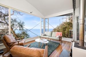 a living room with a view of the ocean at Hideaway At Wye in Wye River