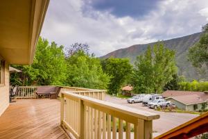 a wooden deck with a view of a mountain at Palmer House in Glenwood Springs
