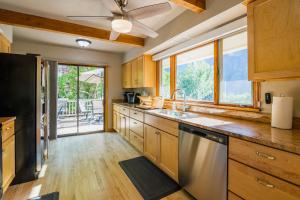 a kitchen with wooden cabinets and a large window at Palmer House in Glenwood Springs