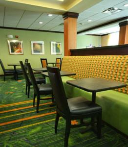 a room with chairs, tables, and tables in it at Fairfield Inn and Suites White River Junction in White River Junction