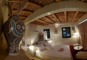 a bedroom with a bed and a large vase at ourika oufla in Ourika