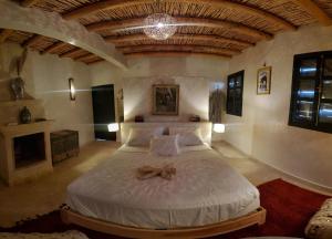 a bedroom with a large bed with a bow on it at ourika oufla in Ourika