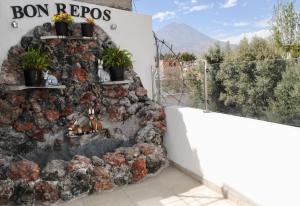 a wall of rocks with plants on it at Bon Repos Boutique in Arequipa