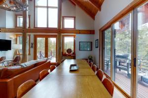 a dining room with a large wooden table and chairs at Boondoggle Basin in Big Sky