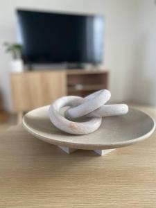 two white rocks sitting on top of a plate at Modern Luxury 1 Bedroom Apartment - Walk to the shops! Free Wifi in Clarkson +6 photos