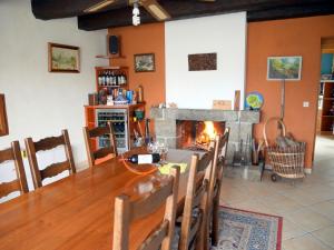 a dining room with a table and a fireplace at Holiday Home in Plouarzel near Sandy Cove in Lampaul-Plouarzel