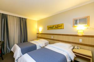 Postel nebo postele na pokoji v ubytování Hotel Exclusivo