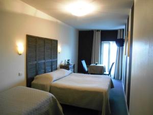 Ένα ή περισσότερα κρεβάτια σε δωμάτιο στο Hôtel de l'Océan