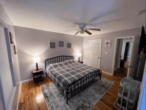 a bedroom with a bed and a ceiling fan at Kid-Friendly Townhouse Near Lake & Sports Complex in Guntersville