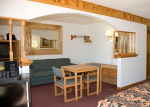 a living room with a table and a couch at North Country Inn & Suites in Mandan