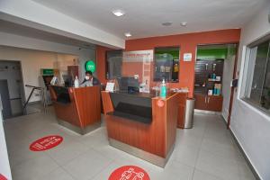 a fast food restaurant with a man sitting at a counter at Casa Andina Standard Machu Picchu in Machu Picchu