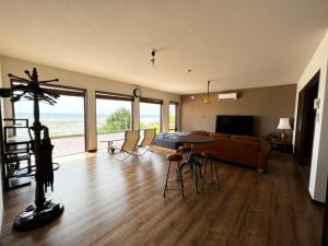 a living room with a table and a couch at ゴールデンマイルヴィラ in Amami