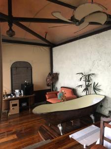 a living room with a surfboard on the wall at Casa maar -Treetop tent in Río Cuarto