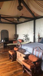 a room with a bed with chairs and a table at Casa maar -Tented Camp in Río Cuarto