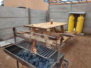 a picnic table with a grill and a fire at Casa La Florida in La Serena