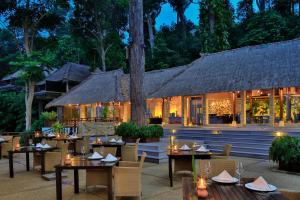 a restaurant with tables and chairs in front of a building at Banyan Tree Bintan in Lagoi