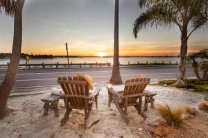 two chairs and a table on a beach with a street at Kokomo by AvantStay Bayside Getaway w Fire Pit Large Outdoor Patio in San Diego