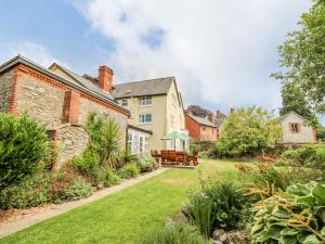 a house with a garden and a yard with a patio at The Laurels in Bishops Castle