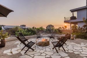 a patio with chairs and a fire pit at Seascape by AvantStay Spacious Contemporary Oasis in Del Mar in San Diego