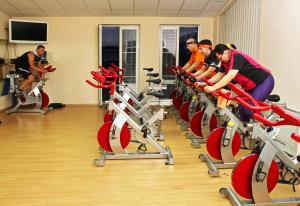a group of people riding on exercise bikes in a gym at Sportpenzion Pohoda in Pilsen
