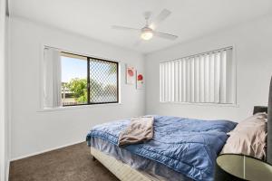 a bedroom with a bed and a window at Bell Street 36 Dicky Beach in Caloundra