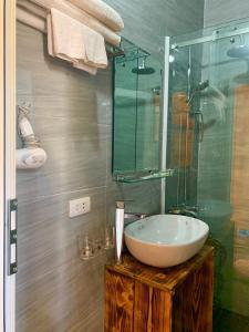 a bathroom with a sink and a glass shower at Mai Chau Countryside Homestay in Mai Châu