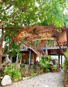 a building with a sign that reads matheny countryside at Mai Chau Countryside Homestay in Mai Chau