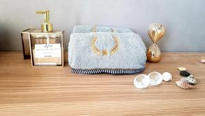 a table with a towel and a box of perfume at Danielle boutique suite in Caesarea