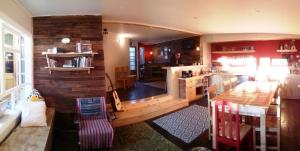 a living room with a kitchen and a dining room at Treehouse Patagonia in Puerto Natales
