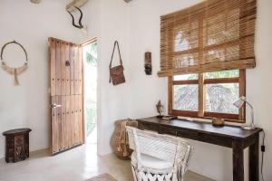 a room with a wooden desk and a window at Holbox island Casa Impala in Holbox Island