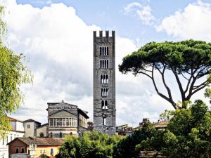 a tall clock tower in the middle of a city at Apartment in Lucca near Piazza Napoleone in Lucca