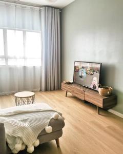 a bedroom with a bed and a flat screen tv at The Hideaway Kuala Terengganu in Kuala Terengganu