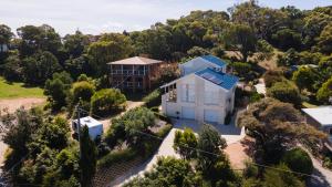 an aerial view of a white house with a blue roof at Sea Haven in Lakes Entrance