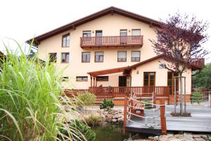 a large house with a river in front of it at Sportpenzion Pohoda in Pilsen