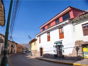 a street in a town with a white building at Casa de Laura in Cusco