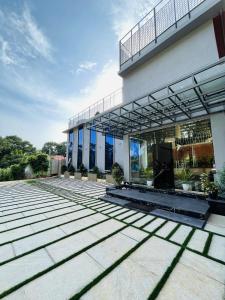 a facade of a building with a patio at Miracle Hotel and Resorts in Kozhikode