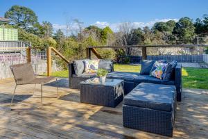a patio with couches and chairs on a wooden deck at Sunshine Cottage in Katoomba