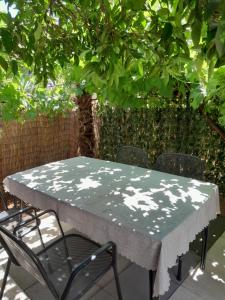 a table and chairs sitting under a tree at MAJA GARDEN in Zadar