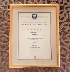 a framed diploma in a wooden frame on a wall at Vila Siam - adults only holiday retreat in Slănic-Moldova