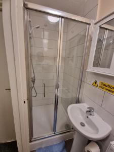 a bathroom with a shower and a sink at Star Homes in London